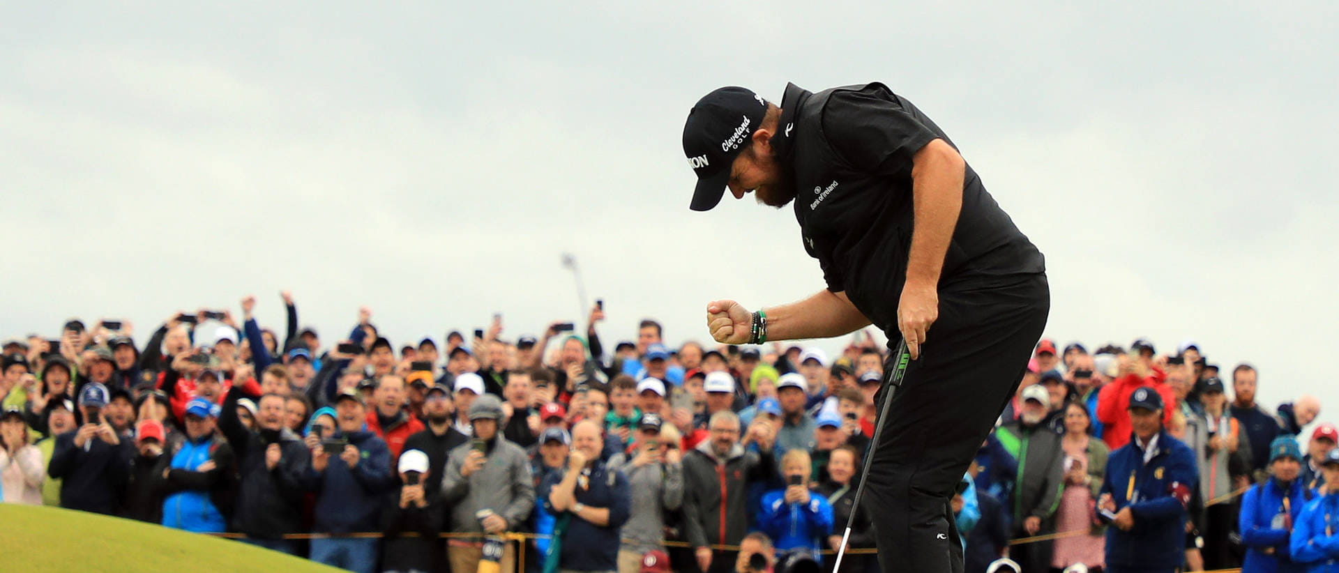 Shane Lowry fist pumping as a raucous crowd celebrates